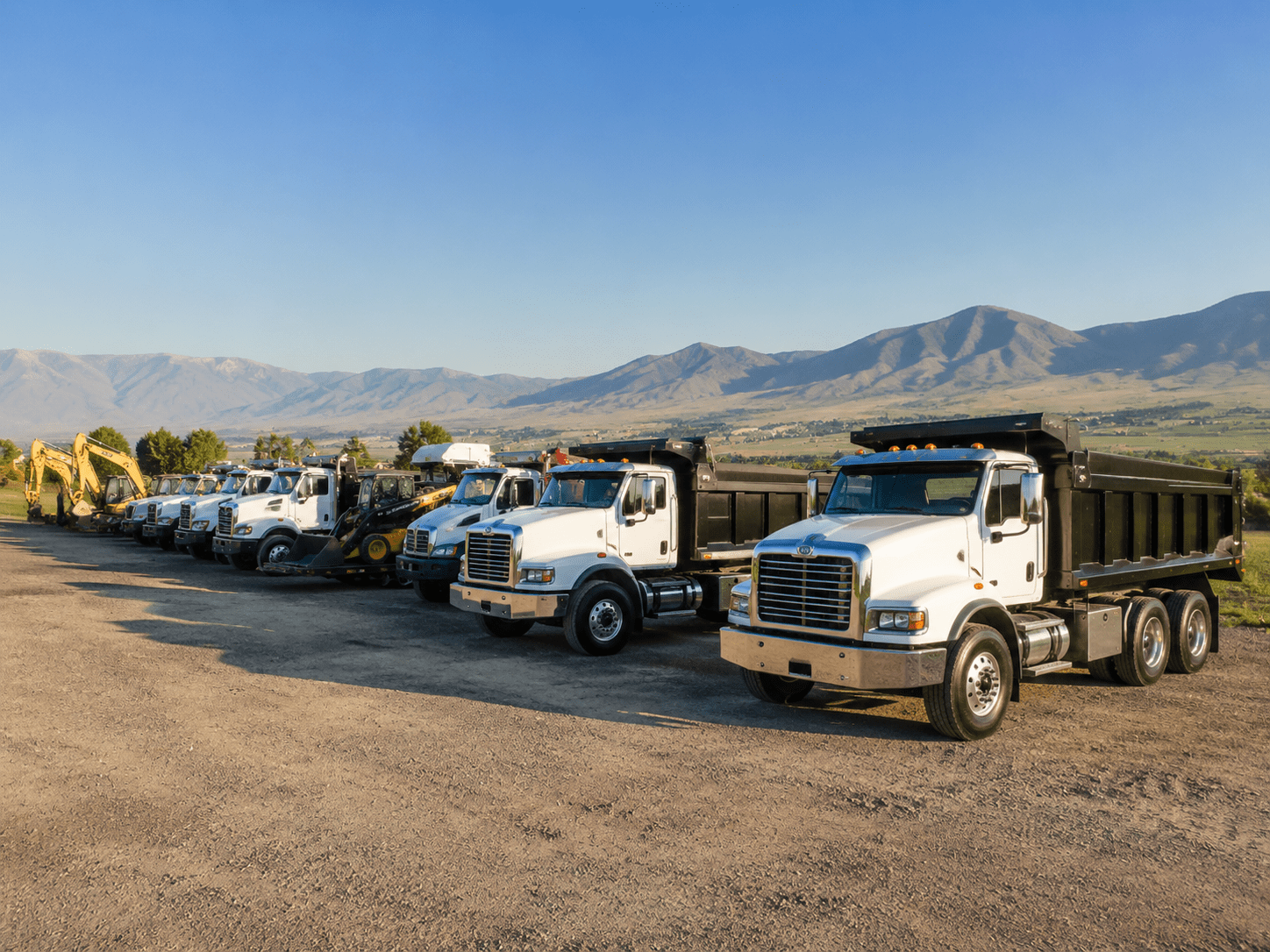 Fleet of commercial dump trucks and heavy machinery in Santaquin UT.